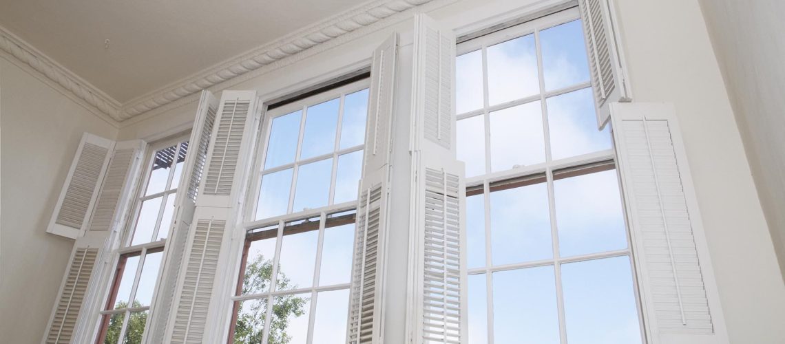 Sky seen through windows with louver shutters